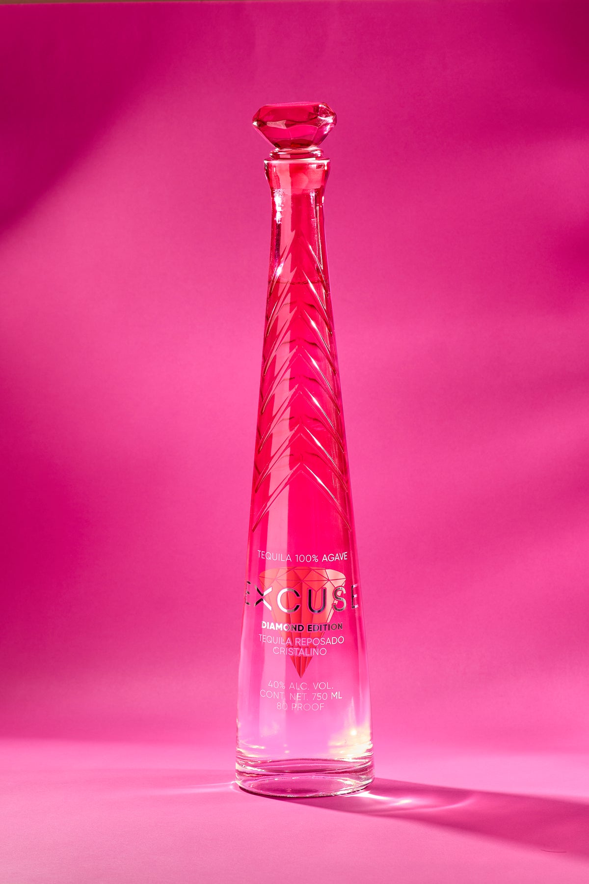 Excuse Tequila Diamond Top Edition bottle, faceted crimson glass with a diamond-cut stopper