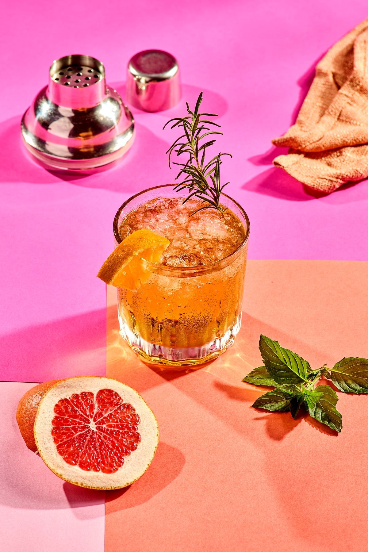 An Excuse Tequila cocktail served over ice with rosemary and citrus