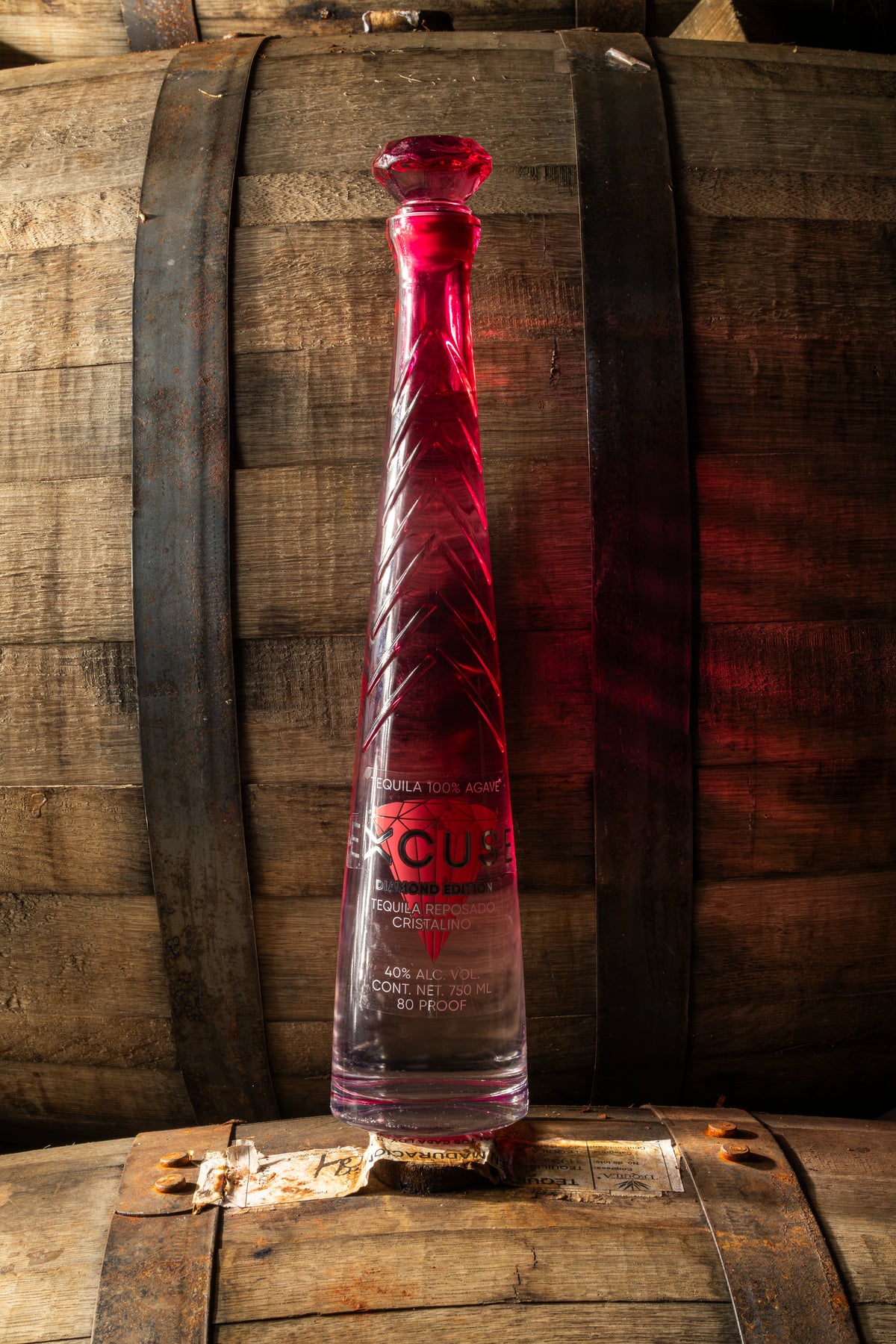 Excuse Tequila Diamond Top Edition bottle resting on an oak cask